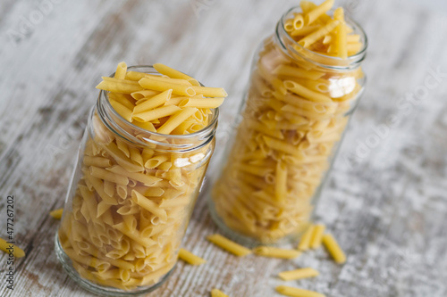 Transparent glass jars with raw pasta