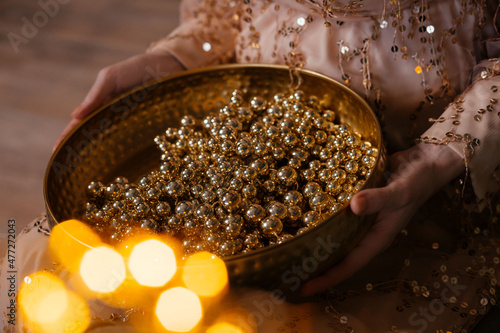 Fotografie, Obraz Gold beads in a gold platter