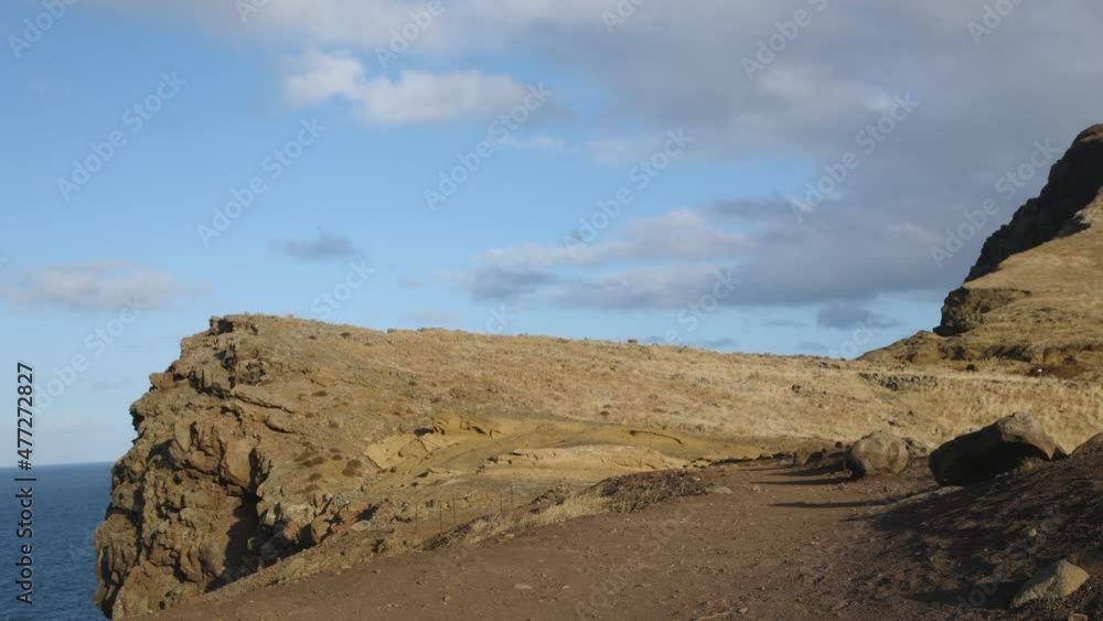 A playful younger boy jumps into the air and kicks with his feet together. Hiker with a backpack. A playful younger boy jumps into the air and kicks with his feet together. Hiker with a backpack.