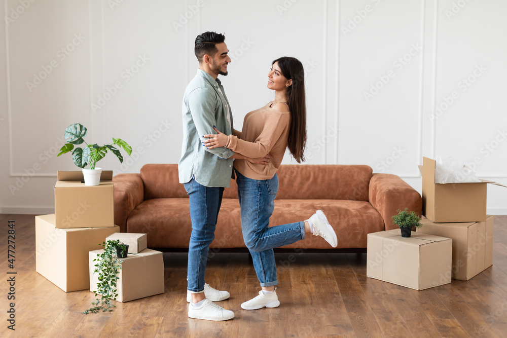 Happy man and woman hugging in their new flat Happy man and woman hugging in their new flat