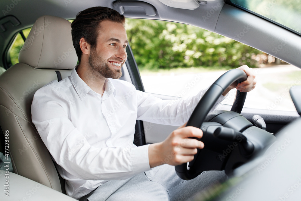 © Prostock-studio - Positive driver businessman in car driving on way to work office, good new personal transport © Prostock-studio - Positive driver businessman in car driving on way to work office, good new personal transport