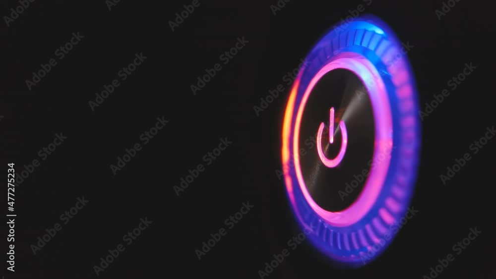 4k macro video loop of a lightning-up computer power button on the system unit on a black background. 4k macro video loop of a lightning-up computer power button on the system unit on a black background.
