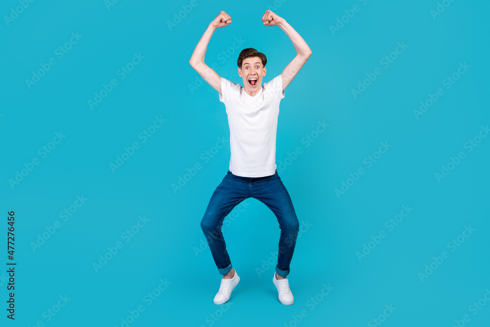 Fototapeta premium Full body photo of young excited man good mood rejoice victory triumph success isolated over blue color background