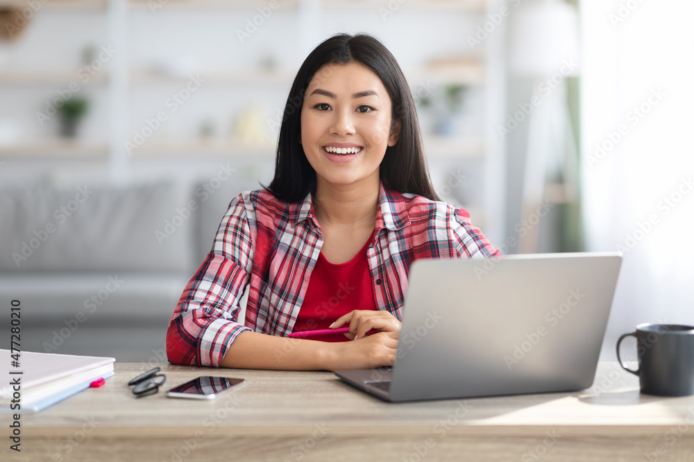 Distance Learning. Smiling Young Asian Female Student Study With Laptop At Home Distance Learning. Smiling Young Asian Female Student Study With Laptop At Home