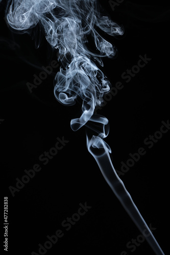 Clouds of curls of smoke on a black background.