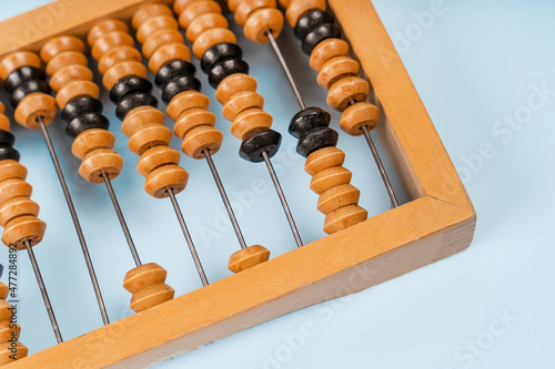 Wooden old abacus on a blue background. Flat lay and top view. Business or accounting concept photo