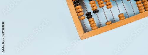 Wooden old abacus on a blue background. Flat lay and top view. Business or accounting concept photo