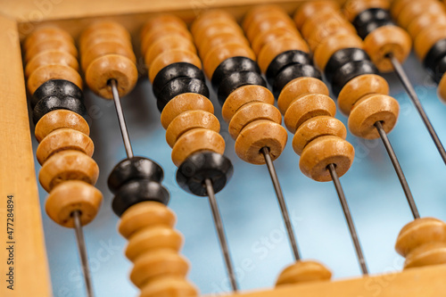Wooden old abacus on a blue background. Flat lay and top view. Business or accounting concept