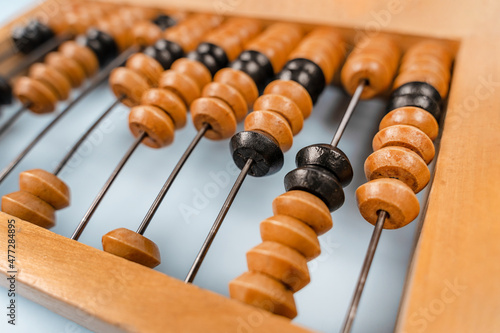 Wooden old abacus on a blue background. Flat lay and top view. Business or accounting concept