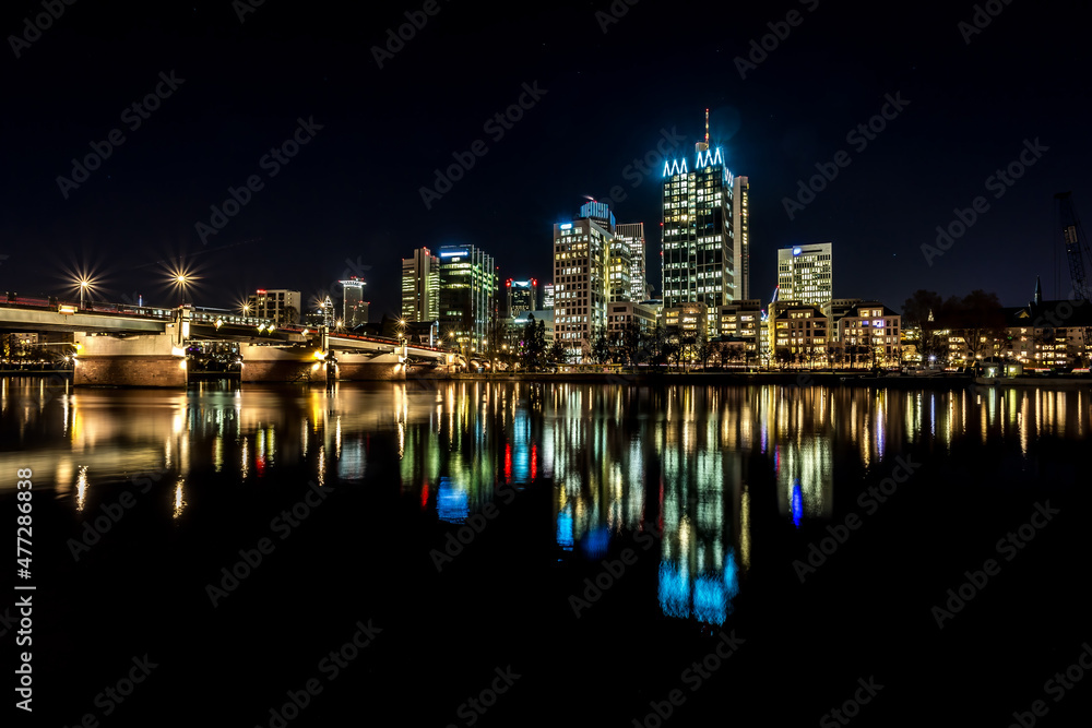 Fototapeta premium The skyline of Frankfurt - Main at night at a cold day in winter.