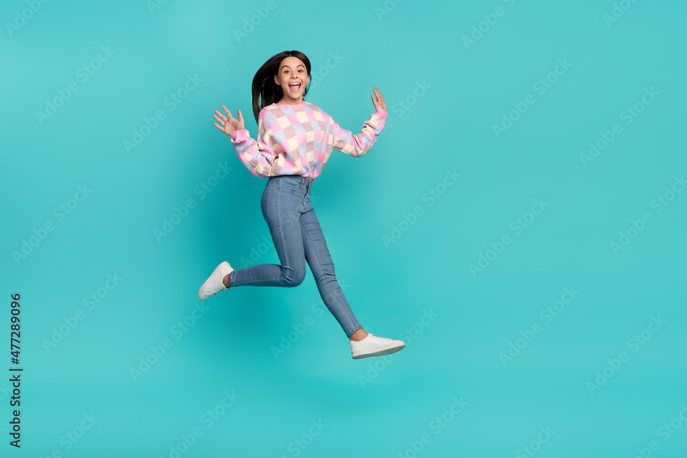 Full length body size view of attractive cheery girl jumping walking good mood isolated over bright teal turquoise color background