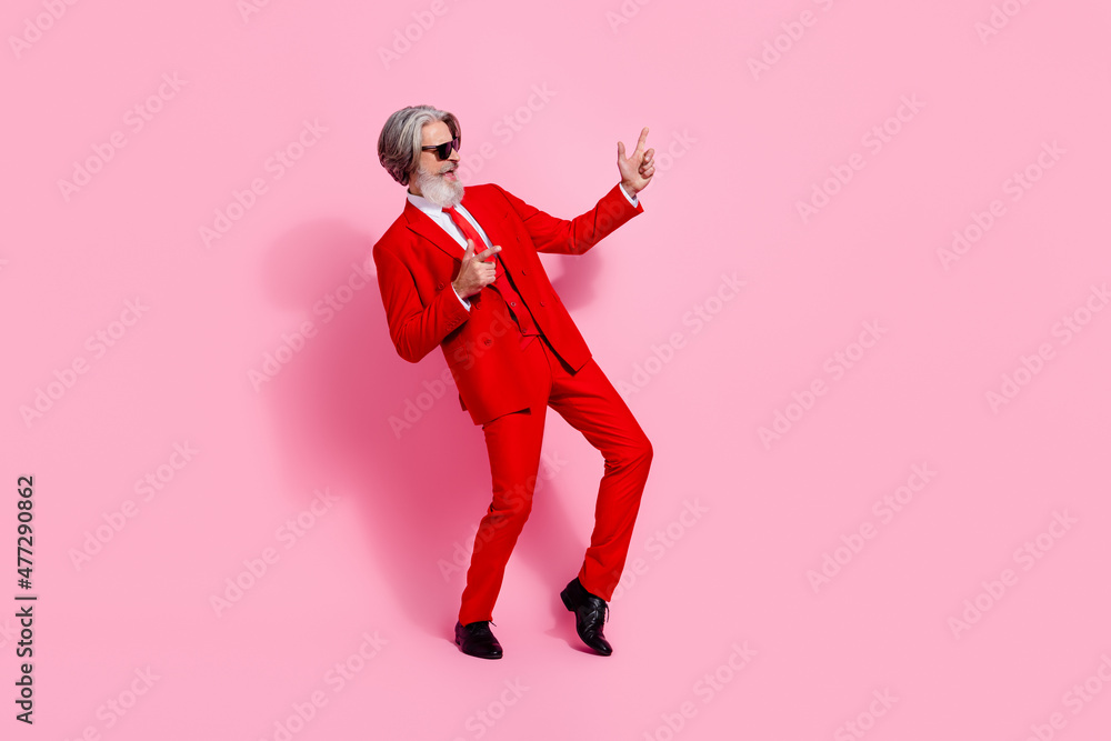 Full length body size view of attractive cheerful grey-haired man dancing enjoying isolated over pink pastel color background Full length body size view of attractive cheerful grey-haired man dancing enjoying isolated over pink pastel color background