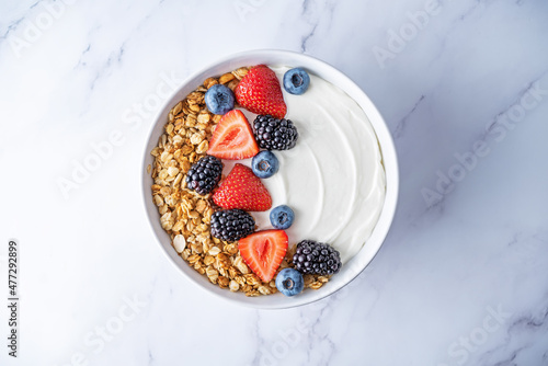 Fresh breakfast with greek yogurt nuts oatmeal granola with berries in a bowl