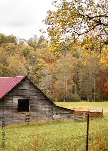 Old red barn in the autumn mountain countryside