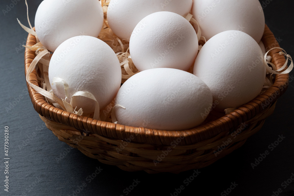 Chicken eggs in wicker basket close up Chicken eggs in wicker basket close up