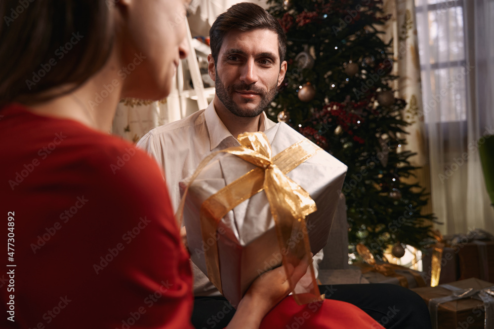 Young people sitting at home and making gift surprises Young people sitting at home and making gift surprises