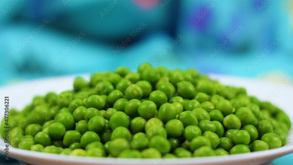 Macro Shot Fresh Organic Green Peas. Healthy Vegetarian food. Close Up Green Peas Background Rotating. Vegetable Harvest Healthy Eating. Beautiful Texture Close-up of Fresh Green Peas.