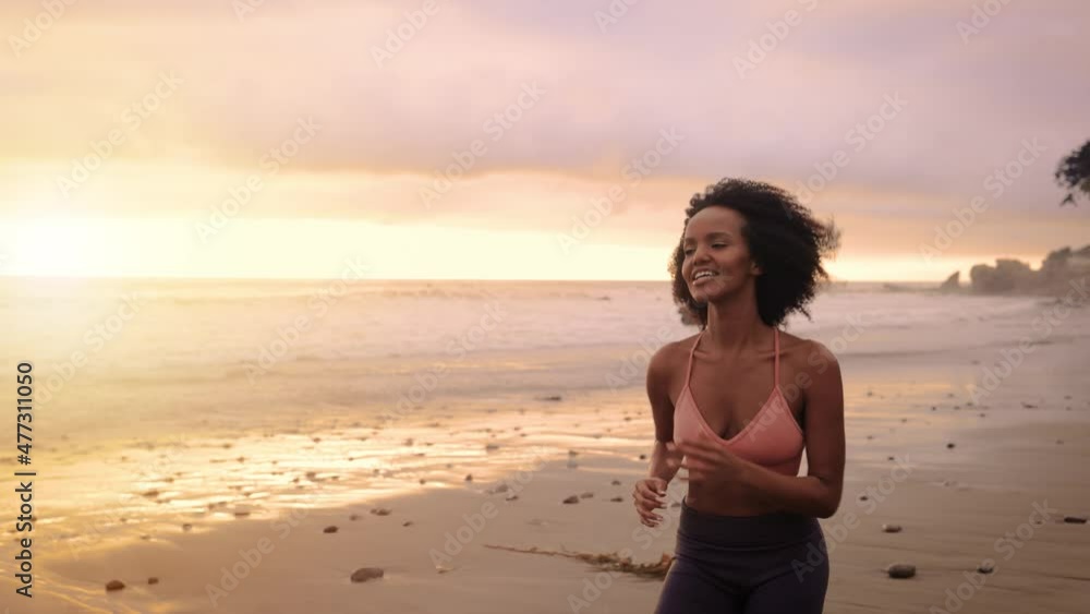 Athletic Somali woman jogging on the beach in Malibu California. Athletic Somali woman jogging on the beach in Malibu California.