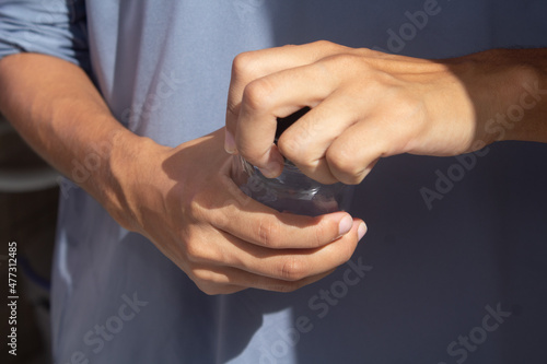Female hands opening a glass jar.
