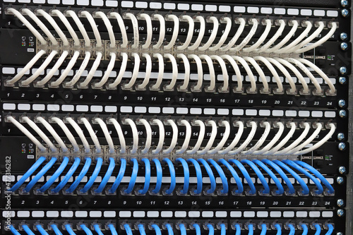 Connecting Ethernet switches to patch panels using colored patch cords in the data center.