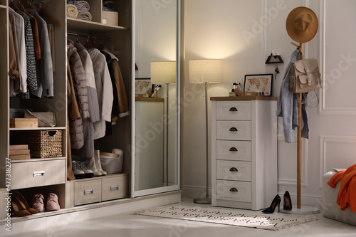 Obraz na plátně Wardrobe closet with different stylish clothes, shoes and home stuff in room