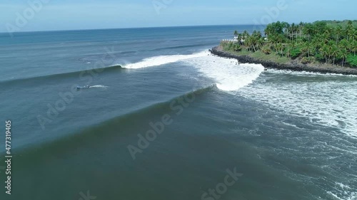 Aerial view of panga going out to the sea, slow motion photo