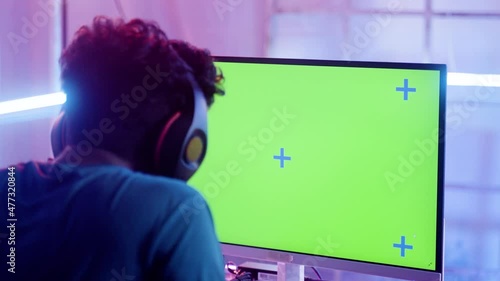 focus on moniter, young professinonal gamer got disappointed due to lost in video game match at champions tournment on green screened mock up - concept of esports, entertainment and live streaming. photo