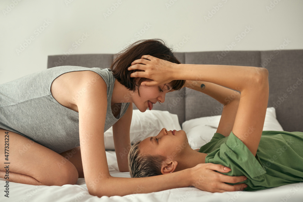 Young lesbian girls resting and touching on bed Young lesbian girls resting and touching on bed