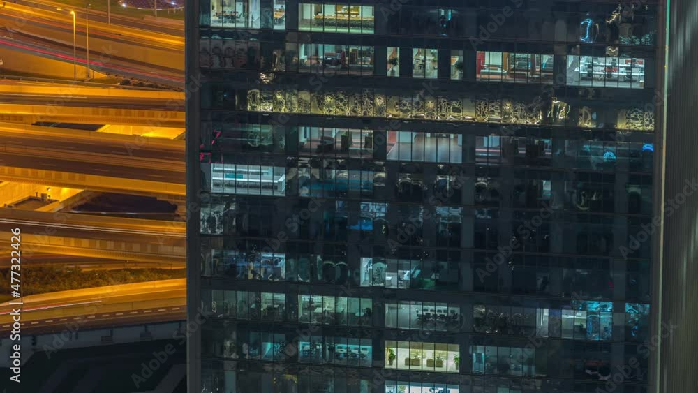 Outside view of windows in offices of a high class building at night timelapse Outside view of windows in offices of a high class building at night timelapse