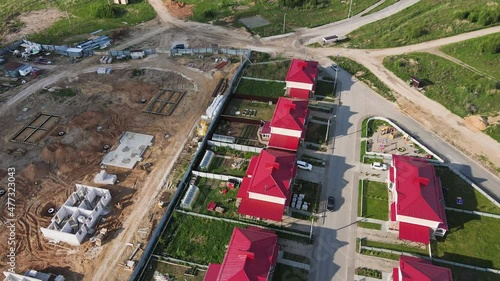 New modern cottages in the suburbs, aerial view. Chalet complex on the outskirts of the city. Business concept, construction, environmentally friendly housing. UHD 4K. photo