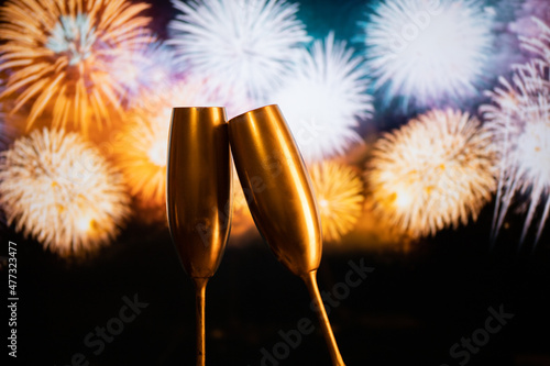 two champagne glasses against fireworks  New Year's eve celebration