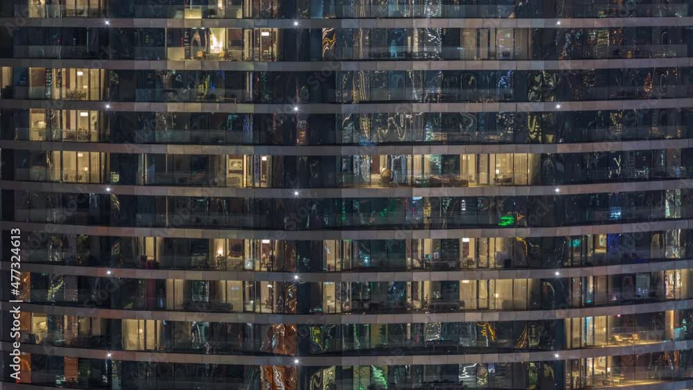 Outside view of windows in apartments of a high class building at night timelapse Outside view of windows in apartments of a high class building at night timelapse