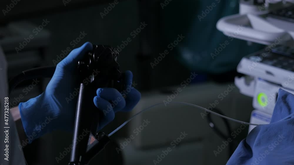 Close-up of doctor hands with endoscope and probe during diagnostic gastroscopy or colonoscopy procedure Close-up of doctor hands with endoscope and probe during diagnostic gastroscopy or colonoscopy procedure