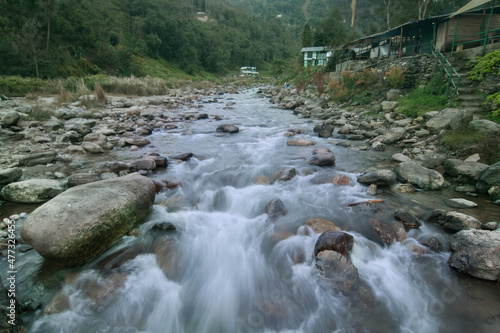 Beautiful Reshi River water flowing through stones and rocks at dawn, Sikkim, India. Reshi is one of the most famous rivers of Sikkim flowing through the state and serving water to many local people. photo