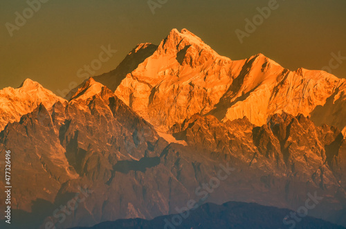 Beautiful first light from sunrise on Mount Kanchenjungha, Himalayan mountain range, Sikkim, India. Orange tint on the mountains at dawn. Close up of the peak.