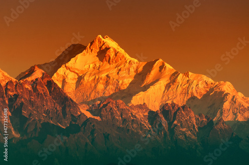 Beautiful first light from sunrise on Mount Kanchenjugha, Himalayan mountain range, Sikkim, India. Orange tint on the Himalayan mountains at dawn.