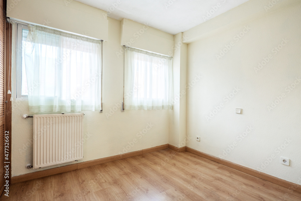 Bedroom with two windows and wardrobe with oak parquet flooring Bedroom with two windows and wardrobe with oak parquet flooring