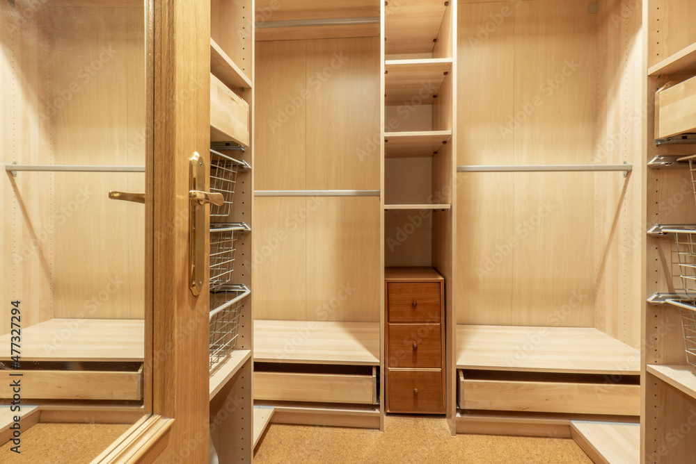 Wardrobe interior with its wooden divisions and bars for hanging clothes