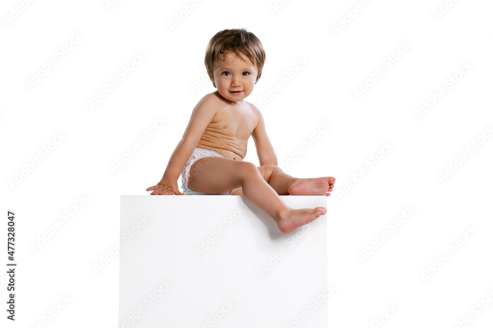 Portrait of little boy, baby, child in diaper isolated over white studio background. Childhood concept Portrait of little boy, baby, child in diaper isolated over white studio background. Childhood concept