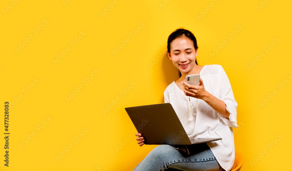 online communication of asian women Portrait of happy Asian business woman using mobile phone isolated on yellow background. online communication concept online communication of asian women Portrait of happy Asian business woman using mobile phone isolated on yellow background. online communication concept