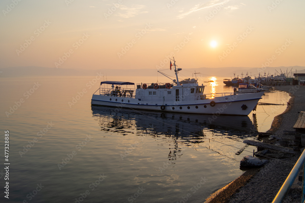 boat at the pier in the sunset on Lake Baikal