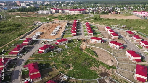 Air view of a modern cottage village in the suburbs. Chalet complex on the outskirts of the city. Business concept, construction, environmentally friendly housing. UHD 4K. photo