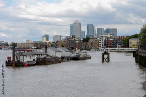 The Cherry Garden Pier on the River Thames with Canary Wharf in the background. Bermondsey, London, UK. photo