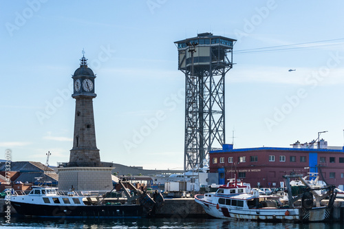 Photography The cable car tower and clock tower overlooking the harbour at Port Vell, Barcelona, Spain
