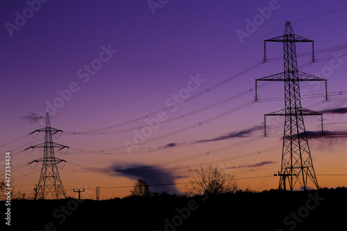 Blue hour shot of pylons silhouetted against the early night sky near Eckington, North East Derbyshire
