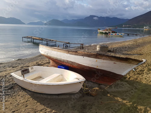  white fishing boats on the sand by the sea sunny weather cloudy sky Marmaris Turkey