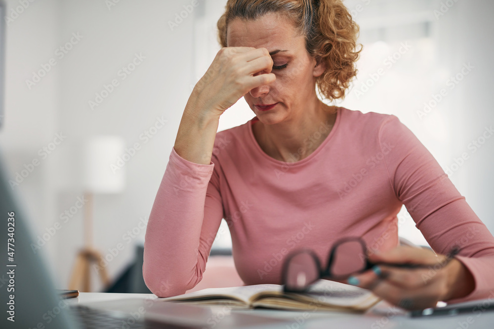 Woman with eyes hurting, sinus problem, headache, head pain, working from home troubles and issues. Woman with eyes hurting, sinus problem, headache, head pain, working from home troubles and issues.