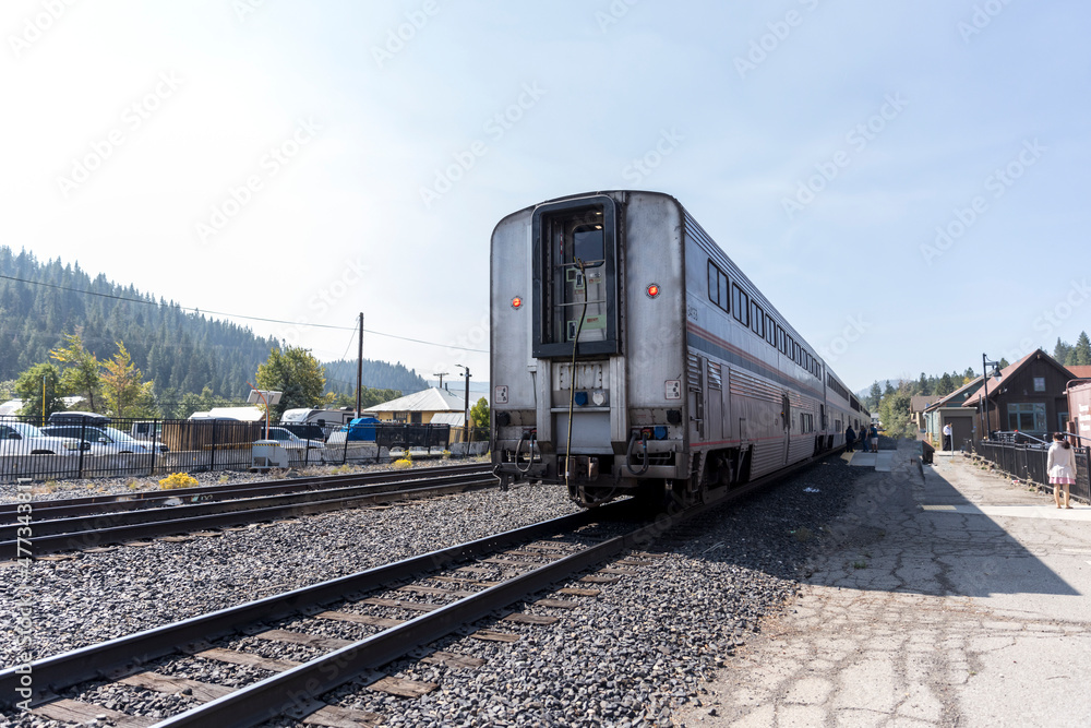 Train on the tracks near parking lot waits for passengers to board Train on the tracks near parking lot waits for passengers to board