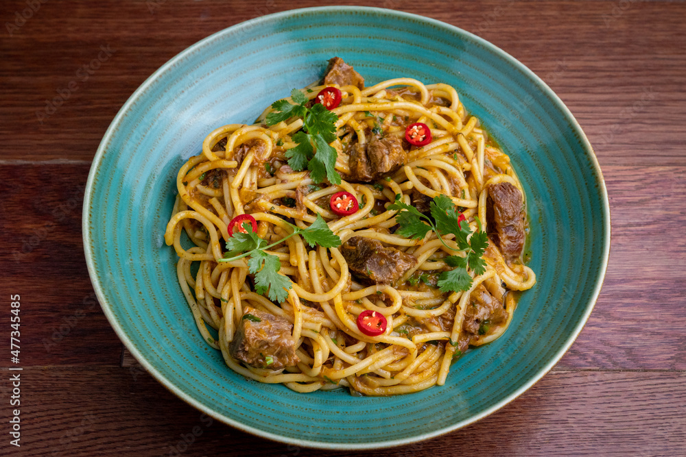 Peruvian pasta with meat cut with knife Peruvian pasta with meat cut with knife