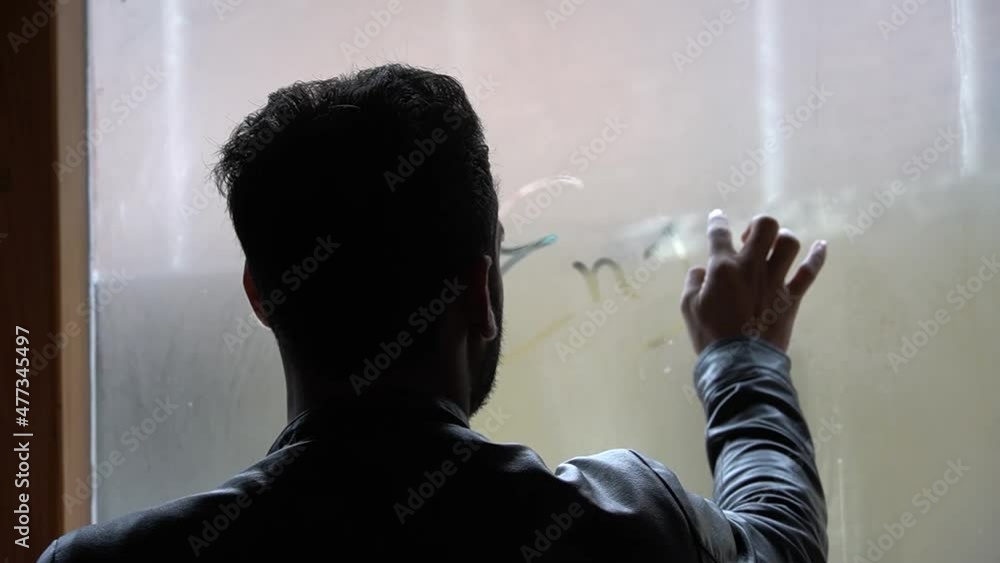 a boy writing on a drop of dew enjoy on window a boy writing on a drop of dew enjoy on window